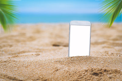 Close-up of laptop on beach