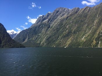 Scenic view of sea and mountains against sky