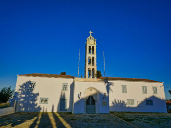 Low angle view of building against clear blue sky