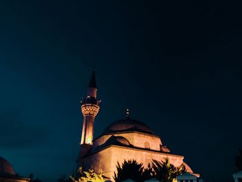 Low angle view of illuminated building against sky at night