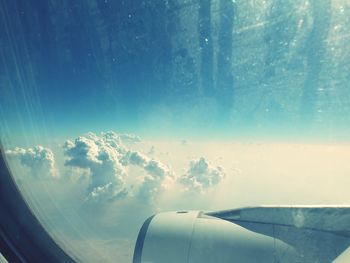 Close-up of airplane wing against sky