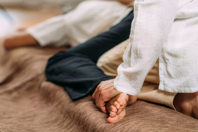 Therapist stretching womans leg. shiatsu massage.