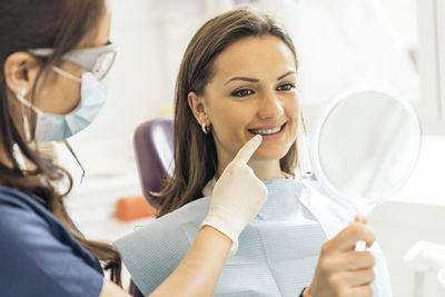 Dentist examining patient mouth in medical clinic