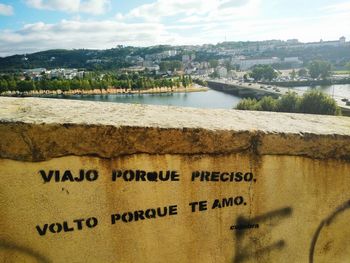 Scenic view of city by sea against sky