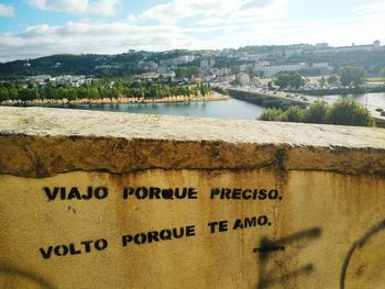 Scenic view of city by sea against sky