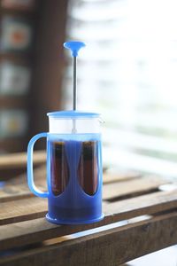 Close-up of french press on table