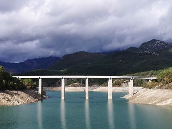 Bridge over mountains against sky