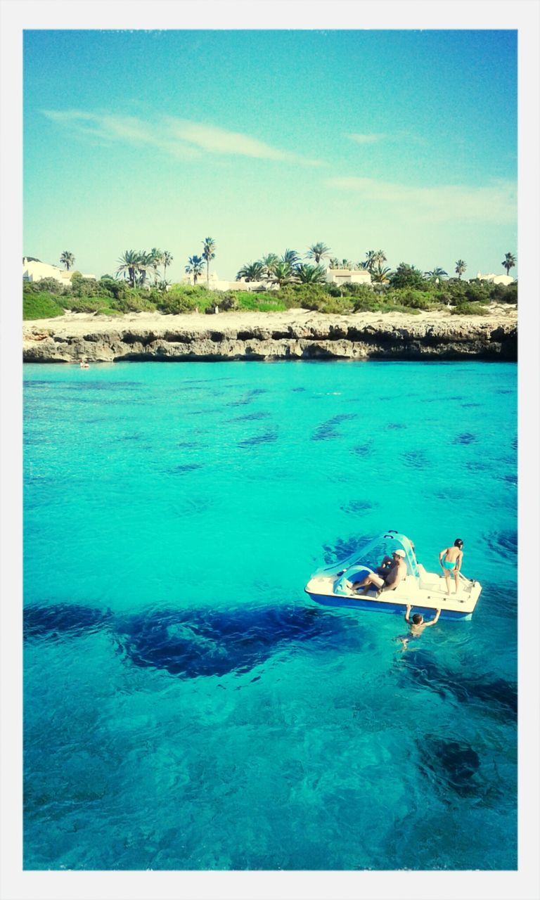 water, transfer print, blue, auto post production filter, sea, nautical vessel, turquoise colored, boat, tranquil scene, tranquility, tree, nature, sky, beauty in nature, transportation, scenics, mode of transport, swimming, day, high angle view