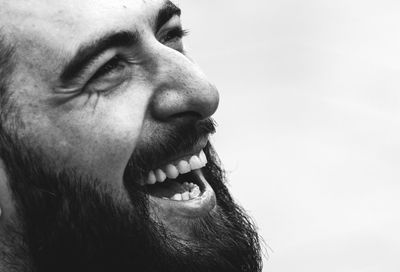 Close-up portrait of man against sky