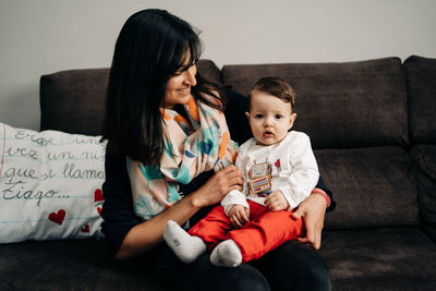 Women sitting on sofa at home