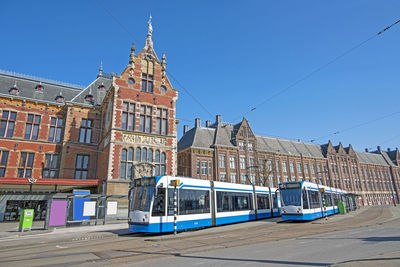 Trams in front of the central station in amsterdam the netherlands