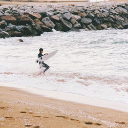 Young man surfing on beach