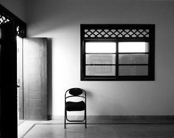 Empty chair by doorway at home