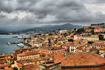 High angle view of townscape by sea against sky