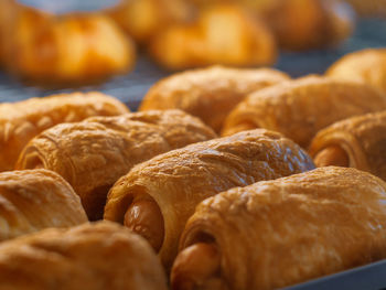 Close-up of croissants in bakery for sale