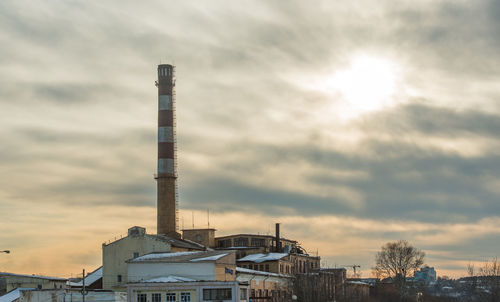 View of factory against cloudy sky