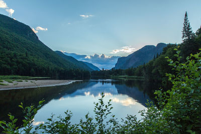 Scenic view of lake and mountains against sky