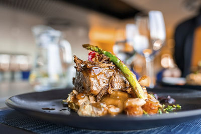 Close-up of yummy gourmet food served in plate on dining table at restaurant