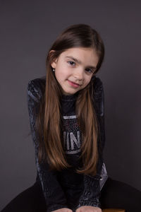 Portrait of a smiling girl against gray background