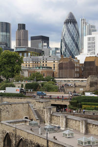 Buildings in city against cloudy sky