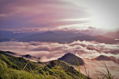 Scenic view of mountains against cloudy sky