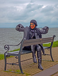 Full length of young woman against sea