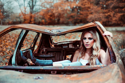 Portrait of young woman in car