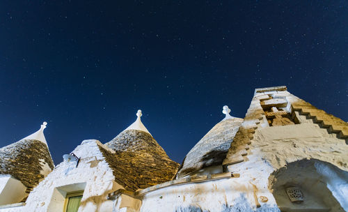 Low angle view of historic building against sky at night