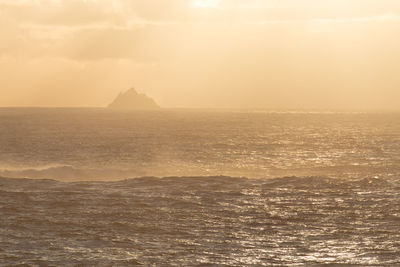 Scenic view of sea against sky at sunset