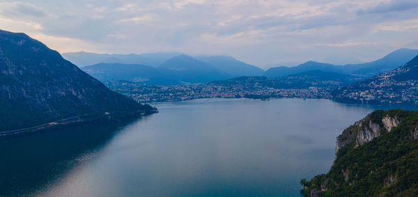 Scenic view of sea and mountains against sky