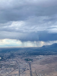 Aerial view of city against cloudy sky