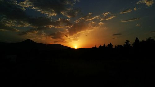 Silhouette of mountain against sky at sunset