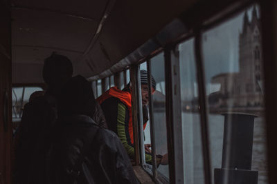 Man peeking through window in boat