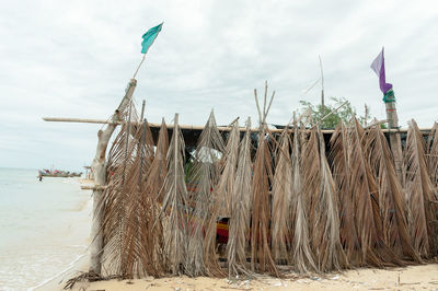 Lifeguard hut on beach against sky