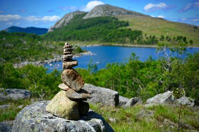 Stacked stones by lake