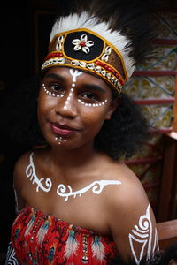 Portrait of native papua woman with traditional face painting