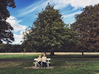 People sitting on bench in park