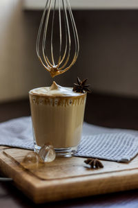 A glass of the popular trendy drink dalgona coffee with milk. whisk and ice. high quality photo