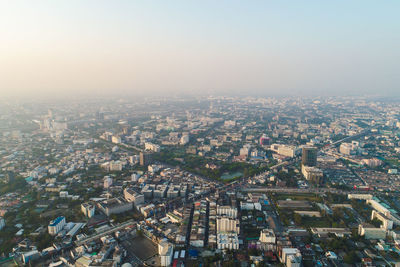 High angle view of illuminated city buildings against sky