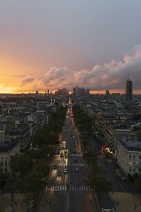 France, ile-de-france, paris, traffic along city street seen from top of arc de triomphe at sunset