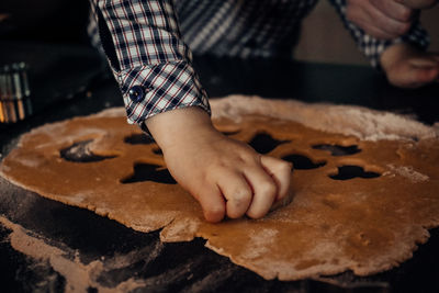 Midsection of child making cookies