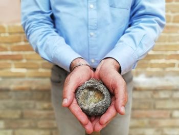 Midsection of man holding ice cream