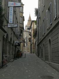 Street amidst buildings against sky in city