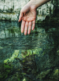 Person touching water in lake