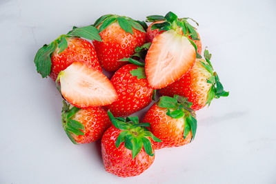 High angle view of strawberries on table against white background