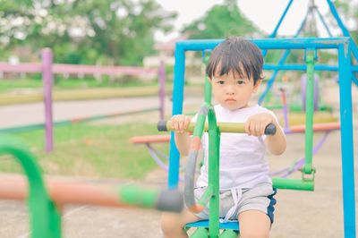 Portrait of cute boy playing on field