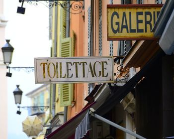 Low angle view of road sign against buildings