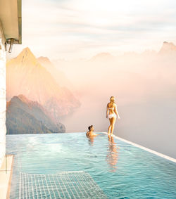 People on swimming pool against sky