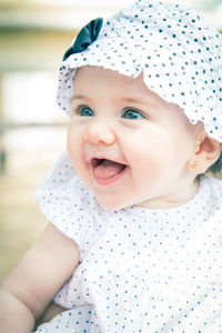 Close-up of cute smiling baby looking away