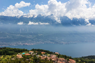 Scenic view of townscape and mountains against sky